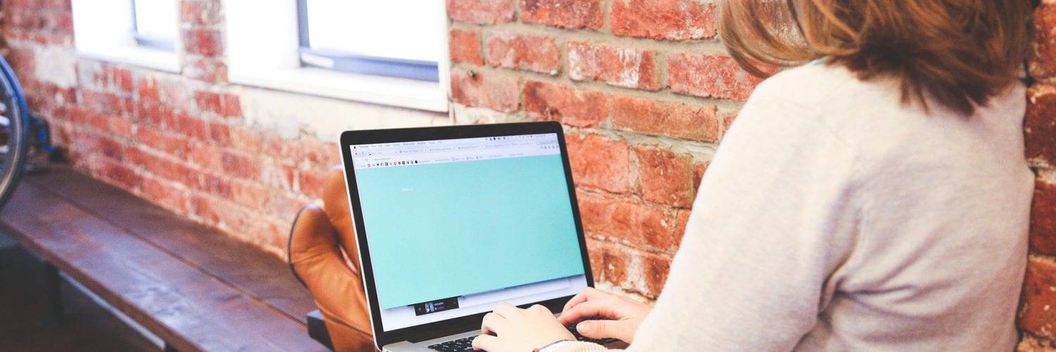 woman sitting with feet up, working on a laptop