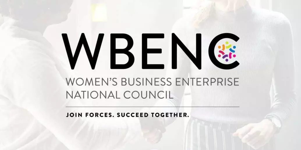 two women shaking hands in a business setting. WBENC logo overlays the image.