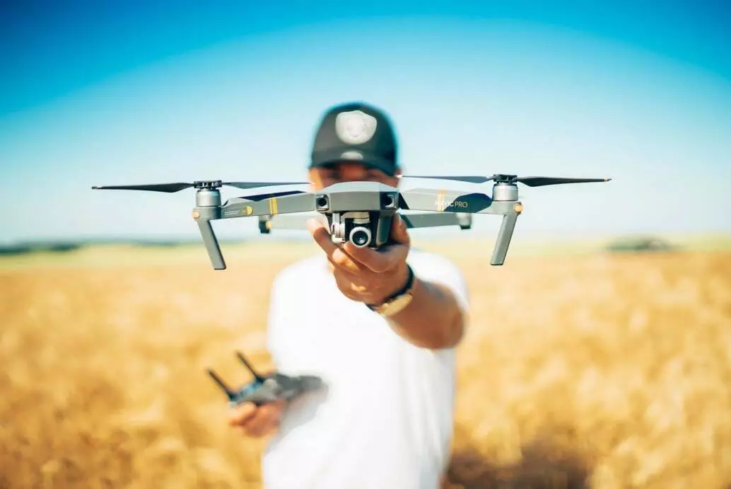 student pilot holding drone and remote control