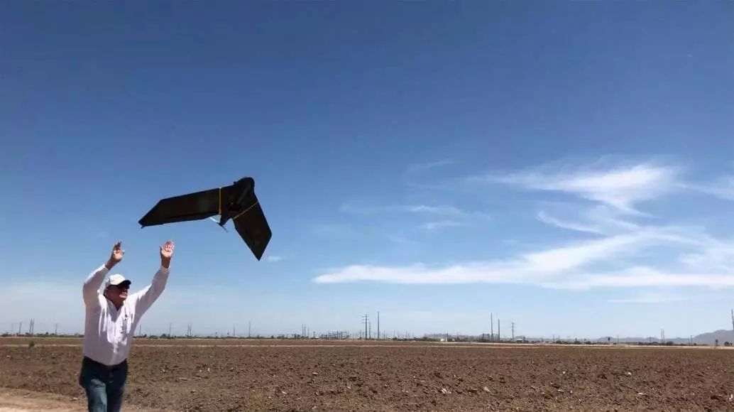 Rich Darling launches a drone for a surveying project in Arizona