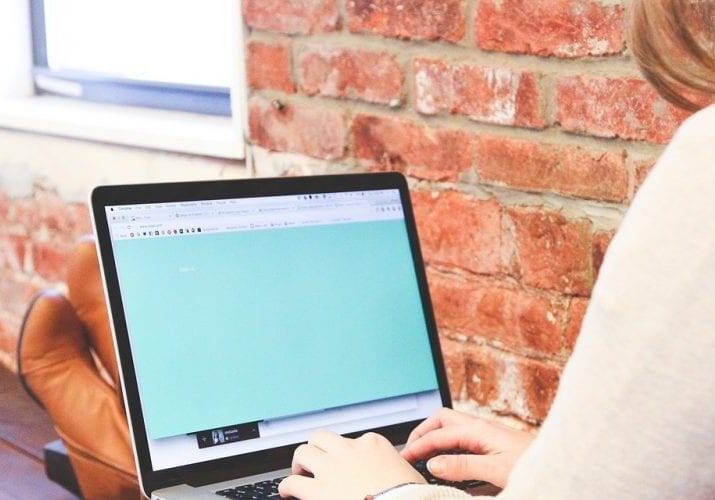 woman sitting with feet up, working on a laptop